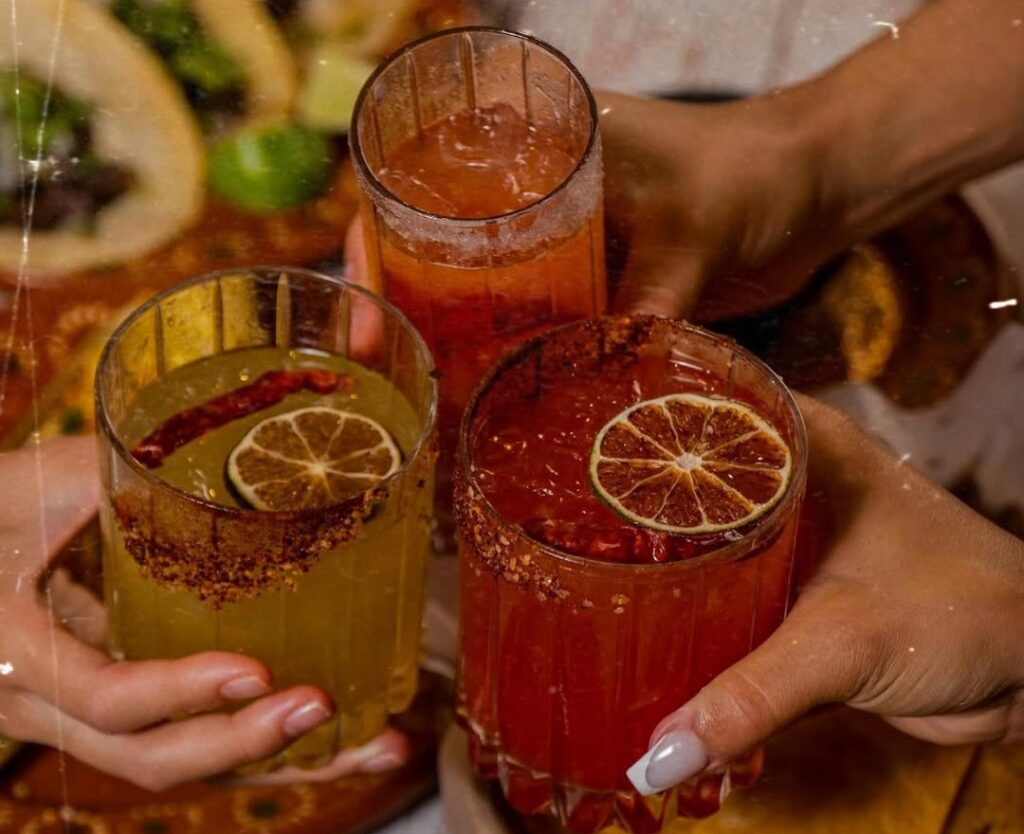 Women toasting with margaritas at Rivales